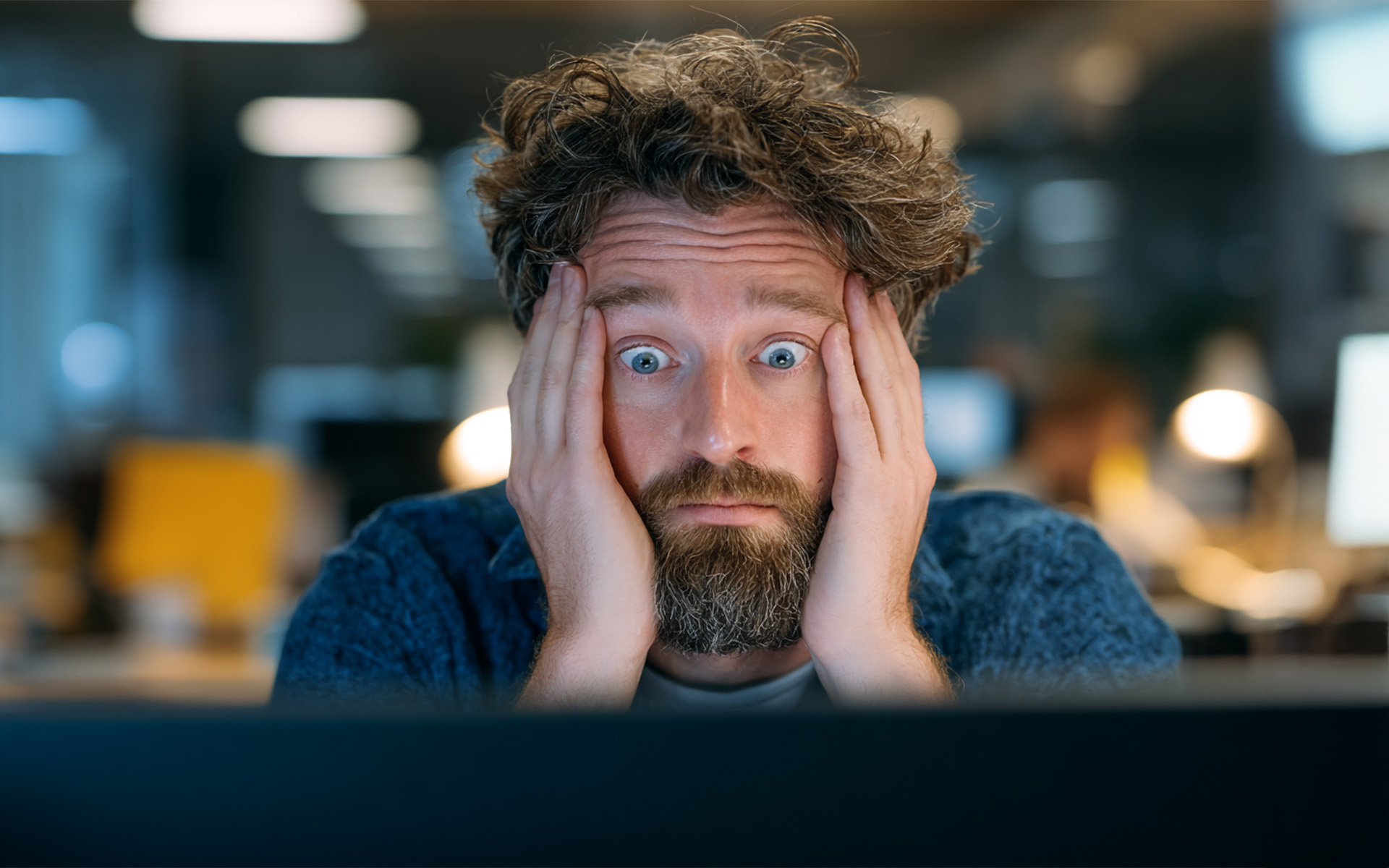 A man sits in front of a computer